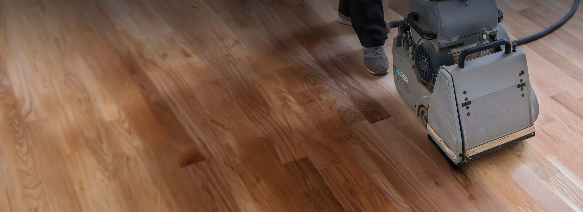 Hardwood floor wood sanding refinishing machine sands the floor.